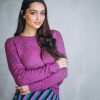 Beautiful woman in a purple sweater and skirt in studio Beautiful woman in a purple sweater and skirt in studio